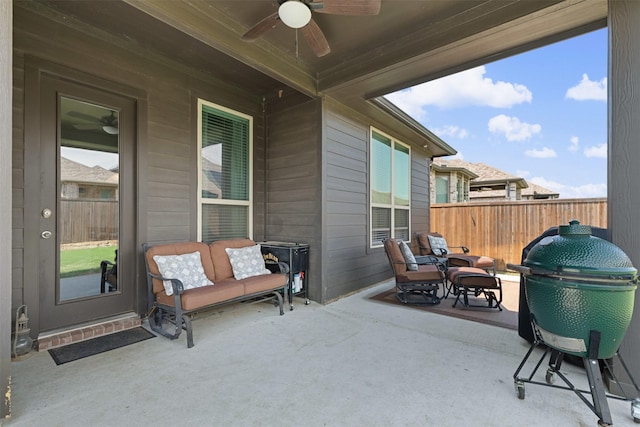 view of patio / terrace with ceiling fan and fence