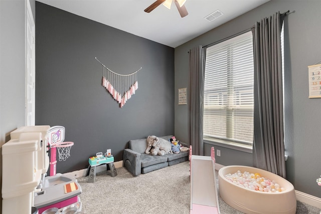 rec room with baseboards, carpet, a ceiling fan, and visible vents