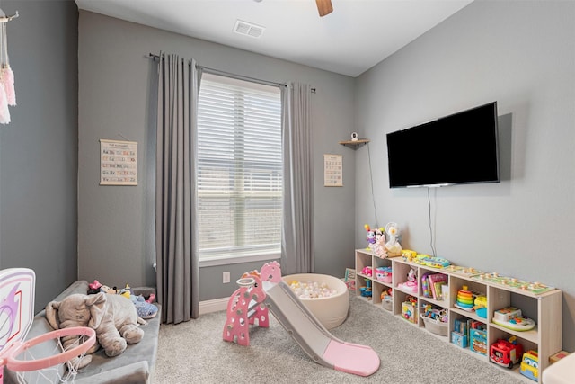 game room featuring a ceiling fan, visible vents, plenty of natural light, and carpet