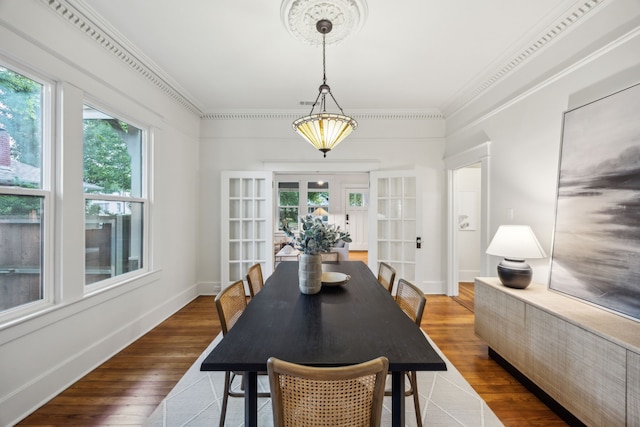 906 N Clinton Ave, Dallas, TX 75208 - dining space with french doors, ornamental molding, baseboards, and wood finished floors