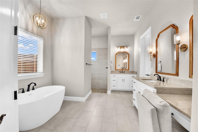 bathroom featuring a walk in shower, a freestanding bath, vanity, tile patterned floors, and visible vents