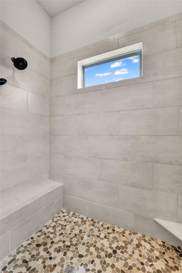 full bath featuring a tile shower