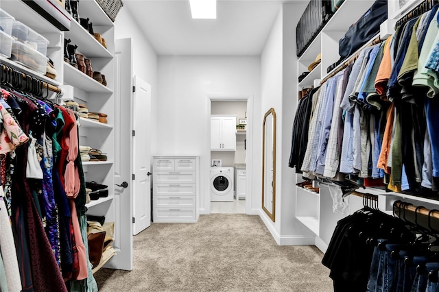 spacious closet with carpet floors and washer / dryer