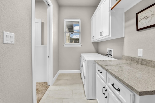 laundry room with baseboards, cabinet space, washing machine and dryer, and light tile patterned flooring