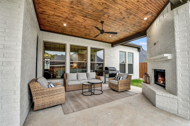view of patio featuring ceiling fan and an outdoor living space with a fireplace