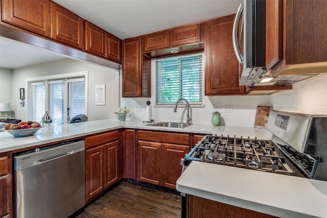 3158 Newcastle Dr, Dallas, TX 75220 - kitchen with decorative backsplash, dark wood-type flooring, light countertops, a sink, and appliances with stainless steel finishes