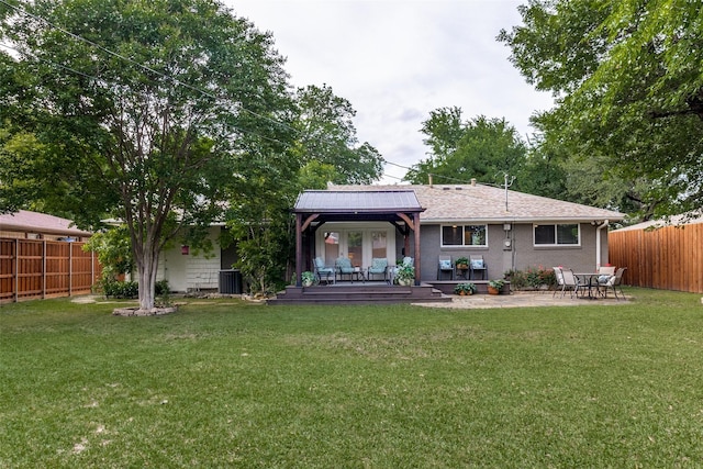 3158 Newcastle Dr, Dallas, TX 75220 - rear view of property featuring a lawn, a fenced backyard, central AC, and a wooden deck