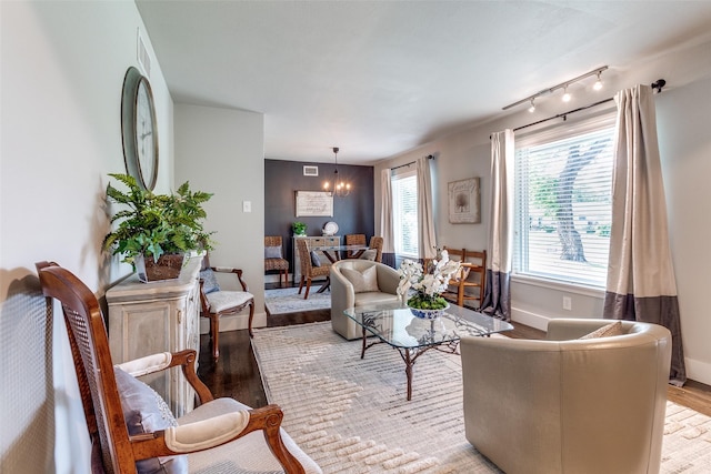 3158 Newcastle Dr, Dallas, TX 75220 - living area with a chandelier, baseboards, visible vents, and wood finished floors