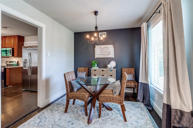3158 Newcastle Dr, Dallas, TX 75220 - dining area with an inviting chandelier, baseboards, wood finished floors, and visible vents