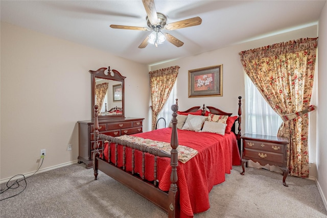 carpeted bedroom with baseboards and a ceiling fan