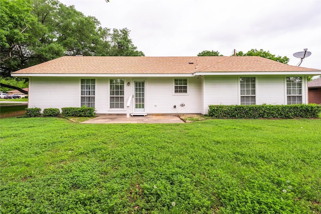 back of house featuring a patio and a lawn