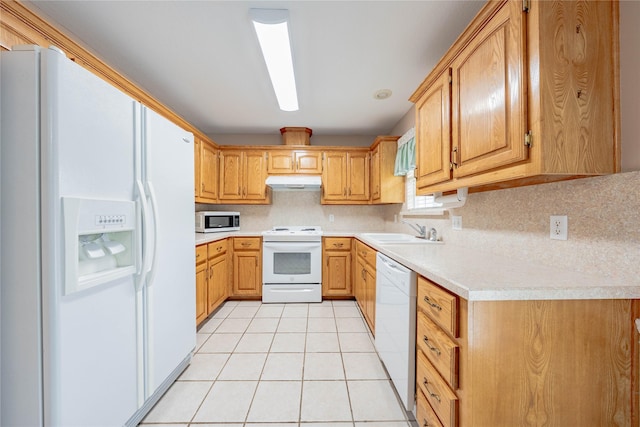 kitchen with decorative backsplash, light countertops, under cabinet range hood, white appliances, and light tile patterned flooring
