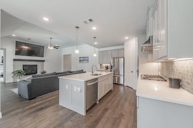 kitchen with ceiling fan, light countertops, stainless steel appliances, decorative backsplash, and visible vents