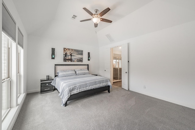 carpeted bedroom featuring a ceiling fan, visible vents, vaulted ceiling, baseboards, and ensuite bathroom
