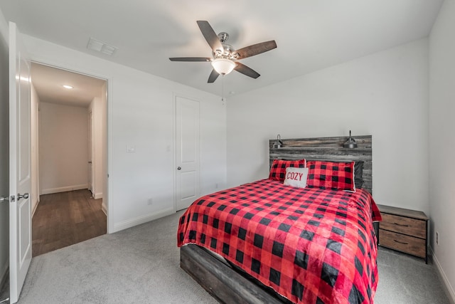 bedroom with carpet floors, baseboards, a ceiling fan, and visible vents