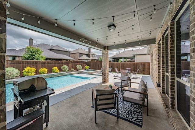 view of pool featuring a patio, a pool with connected hot tub, a fenced backyard, and a grill