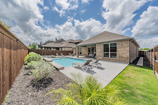 view of swimming pool featuring a patio area, a hot tub, a fenced in pool, a fenced backyard, and a yard
