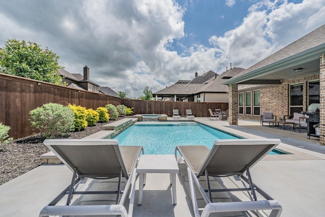 view of pool featuring a fenced in pool, a fenced backyard, an in ground hot tub, a patio area, and a grill