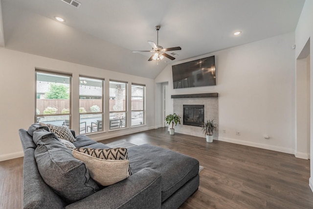 living area with a ceiling fan, baseboards, a glass covered fireplace, and wood finished floors