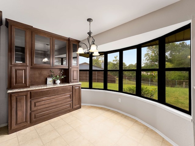 unfurnished dining area with baseboards and a healthy amount of sunlight
