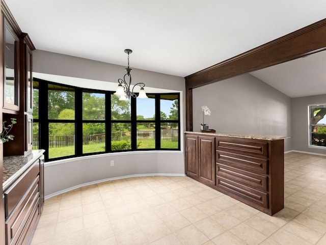 unfurnished dining area with an inviting chandelier and baseboards