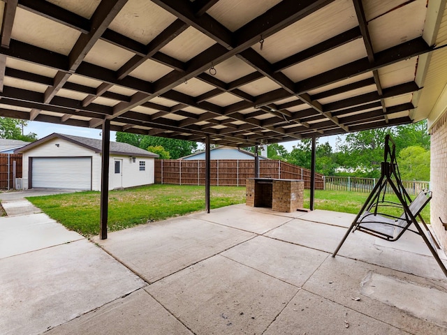 view of patio featuring an outdoor structure, a fenced backyard, and a garage