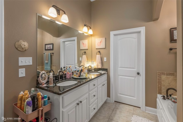 bathroom featuring a sink, baseboards, tile patterned flooring, and double vanity
