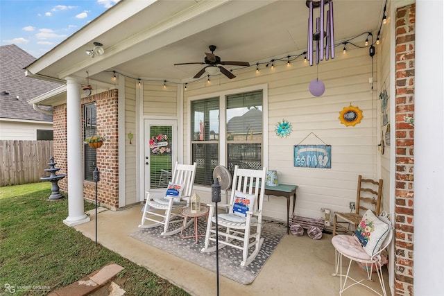view of patio / terrace with fence and a ceiling fan
