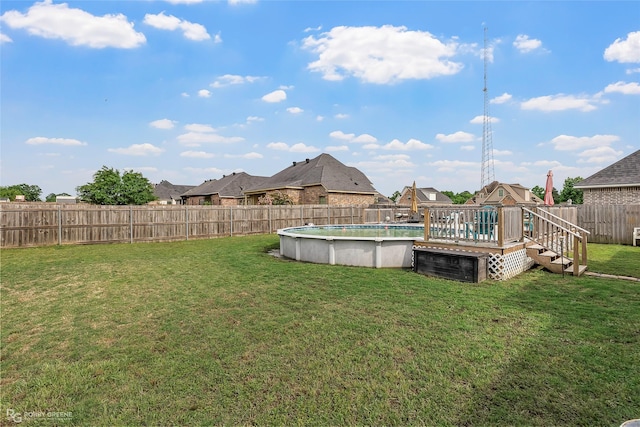 view of yard featuring a fenced backyard, a fenced in pool, and a playground