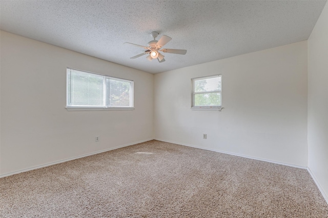 2400 N Shore Dr, Bonham, TX 75418 - carpeted spare room with baseboards, a ceiling fan, and a textured ceiling