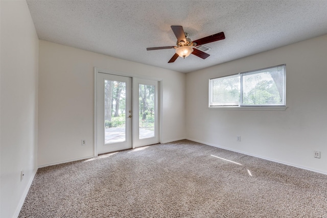 2400 N Shore Dr, Bonham, TX 75418 - carpeted spare room featuring visible vents, a ceiling fan, a textured ceiling, and baseboards