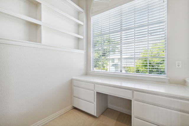 unfurnished office featuring built in desk