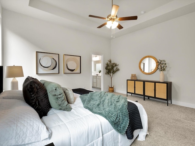 carpeted bedroom with baseboards, ceiling fan, and ensuite bathroom
