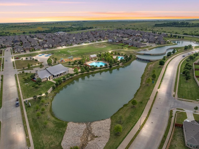 drone / aerial view with a water view and a residential view