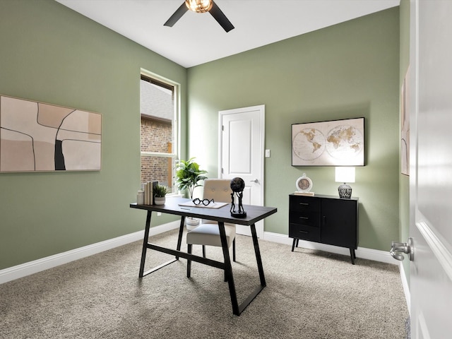 carpeted home office with baseboards and ceiling fan