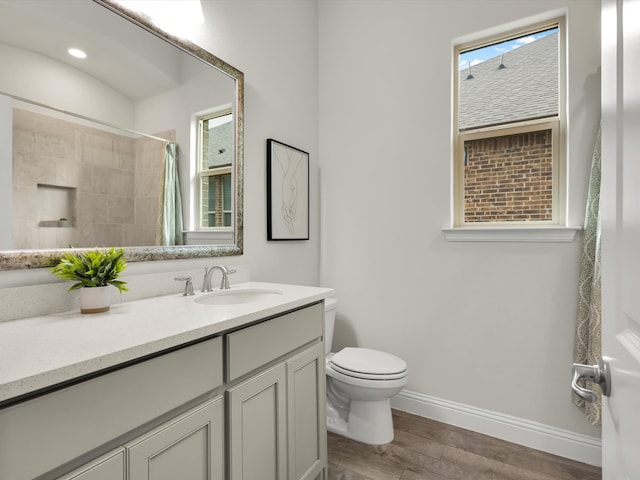 full bath with vanity, toilet, baseboards, wood finished floors, and a shower with curtain