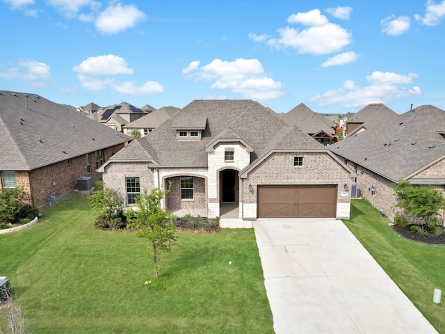 french country home with cooling unit, roof with shingles, brick siding, driveway, and a residential view