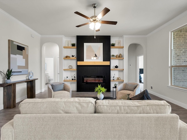 living area featuring crown molding, arched walkways, and wood finished floors