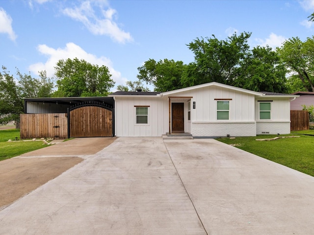 1821 Melissa St, Arlington, TX 76010 - view of front of property featuring a front lawn, fence, brick siding, board and batten siding, and driveway