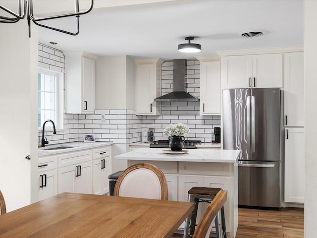 1821 Melissa St, Arlington, TX 76010 - kitchen with decorative backsplash, visible vents, a sink, freestanding refrigerator, and wall chimney exhaust hood