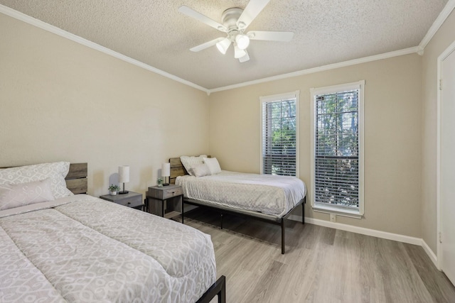 bedroom featuring crown molding, a textured ceiling, and wood finished floors