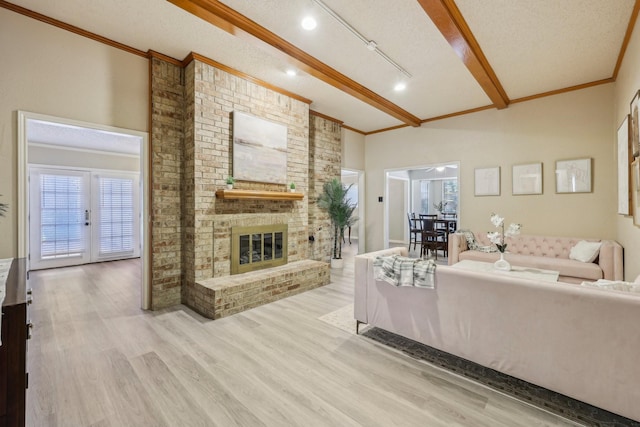 living room featuring crown molding, vaulted ceiling with beams, a brick fireplace, and wood finished floors