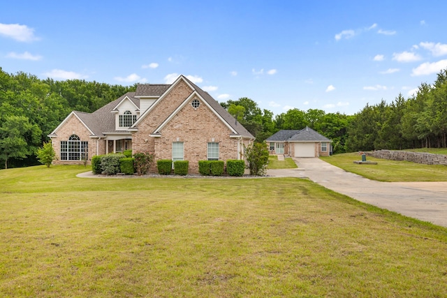 traditional-style house with a garage, a front lawn, and brick siding