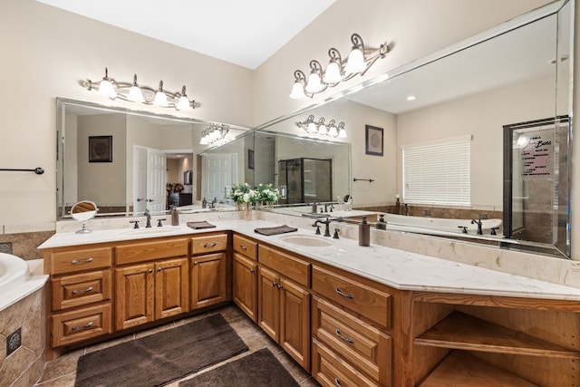 full bathroom featuring double vanity, a sink, a bath, and a stall shower