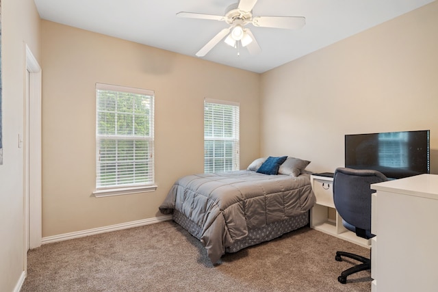carpeted bedroom featuring baseboards and ceiling fan