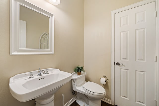 half bathroom with a sink and toilet