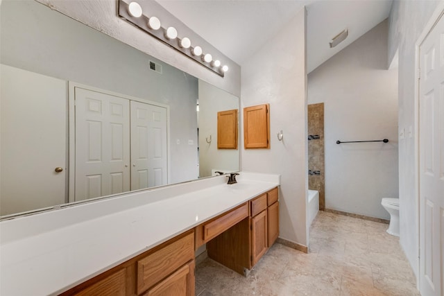 bathroom featuring visible vents, lofted ceiling, toilet, and vanity