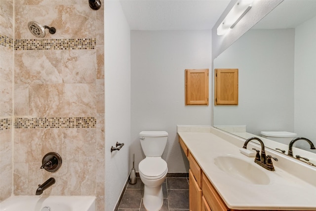 bathroom featuring vanity, toilet, tile patterned floors, baseboards, and shower / washtub combination