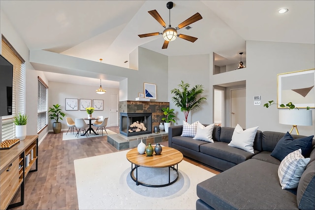 living area featuring high vaulted ceiling, a ceiling fan, recessed lighting, and wood finished floors