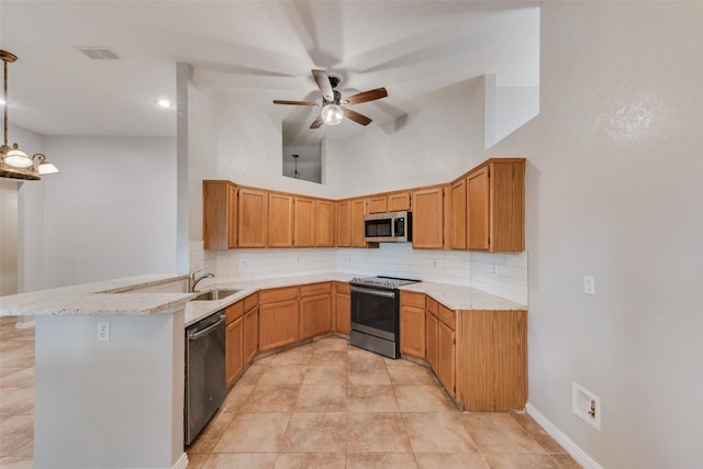 kitchen with appliances with stainless steel finishes, decorative backsplash, a peninsula, and visible vents